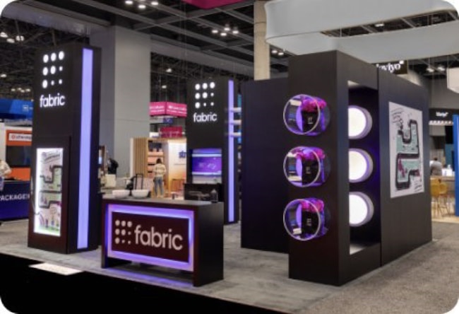 A display booth illuminated by purple lights, featuring a prominent sign, creating an inviting atmosphere.