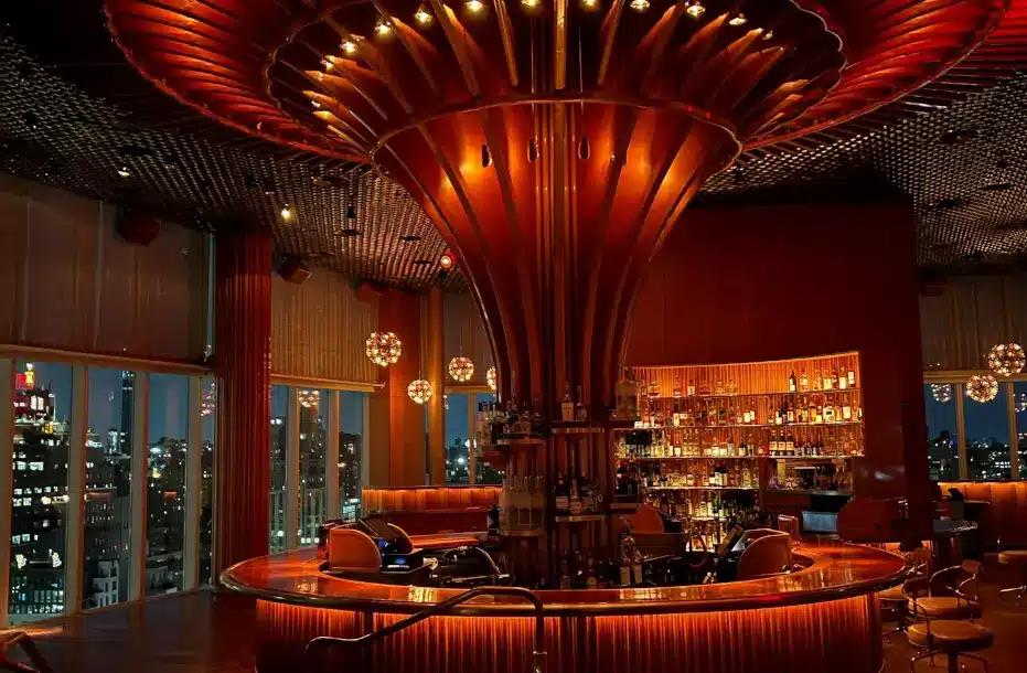 A stylish bar adorned with a large circular light fixture, enhancing the ambiance of the establishment.